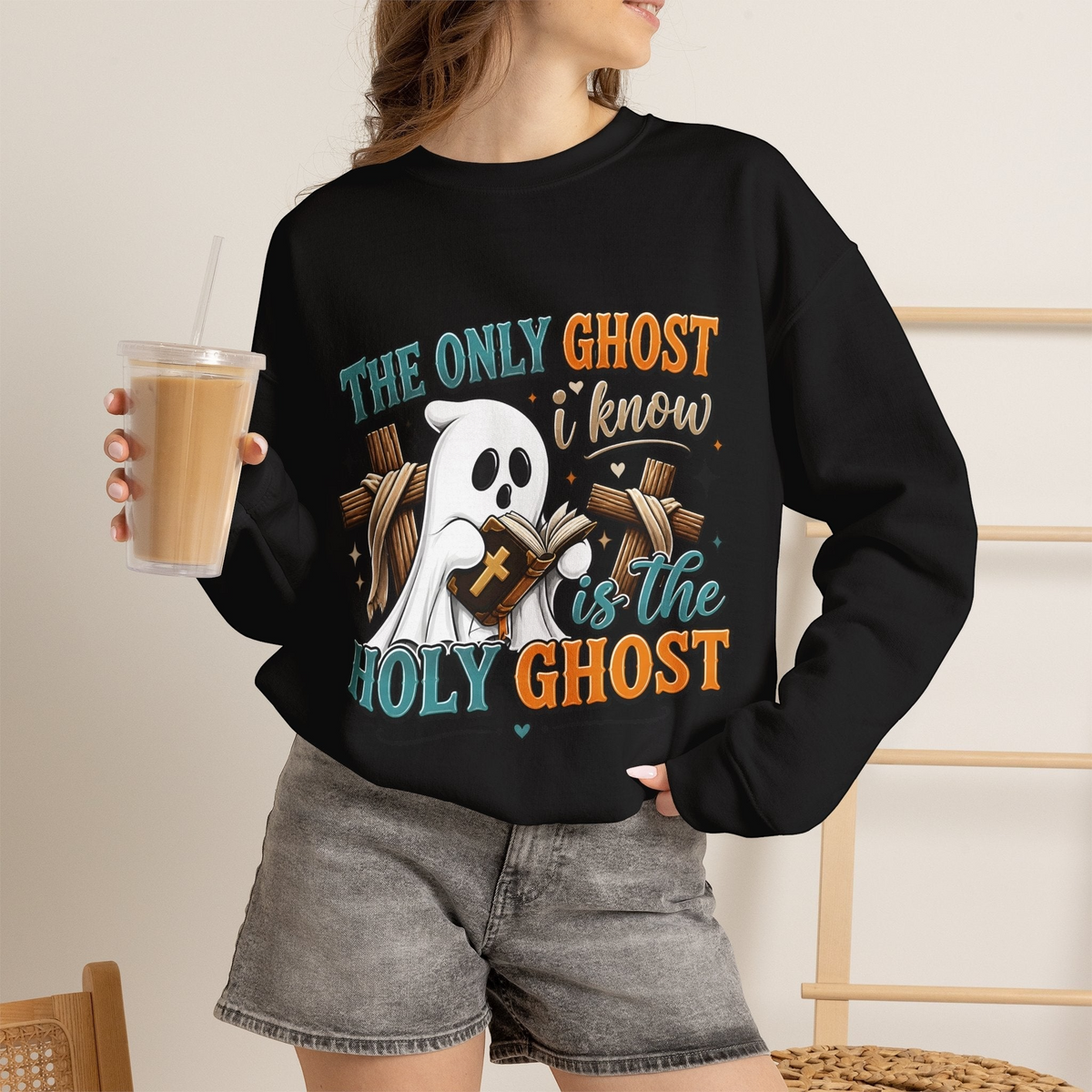 Crown N Thread black crewneck sweatshirt featuring a cute ghost reading a Bible with cross and faith-themed text.