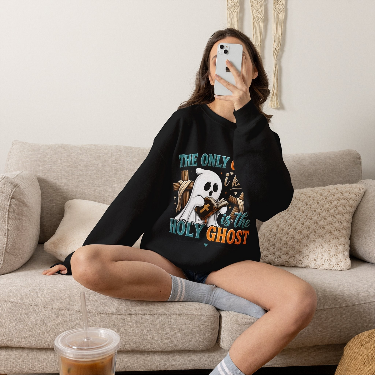 Woman wearing a black Crown N Thread crewneck sweatshirt with a cute ghost graphic reading The Only Ghost I Know