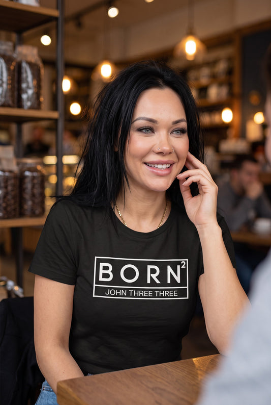 Woman wearing a black Crown N Thread cotton graphic tee with a white BORN2 John Three Three box logo in a cafe