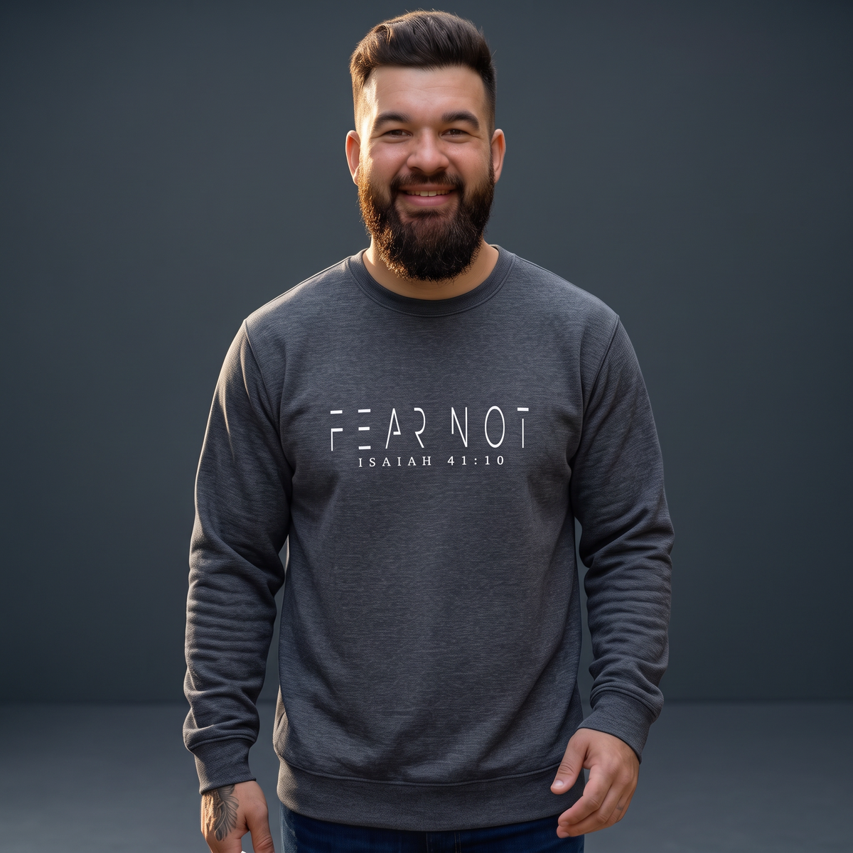 A smiling man wearing a Crown N Thread charcoal grey crewneck sweatshirt with Fear Not Isaiah 41:10 embroidery.