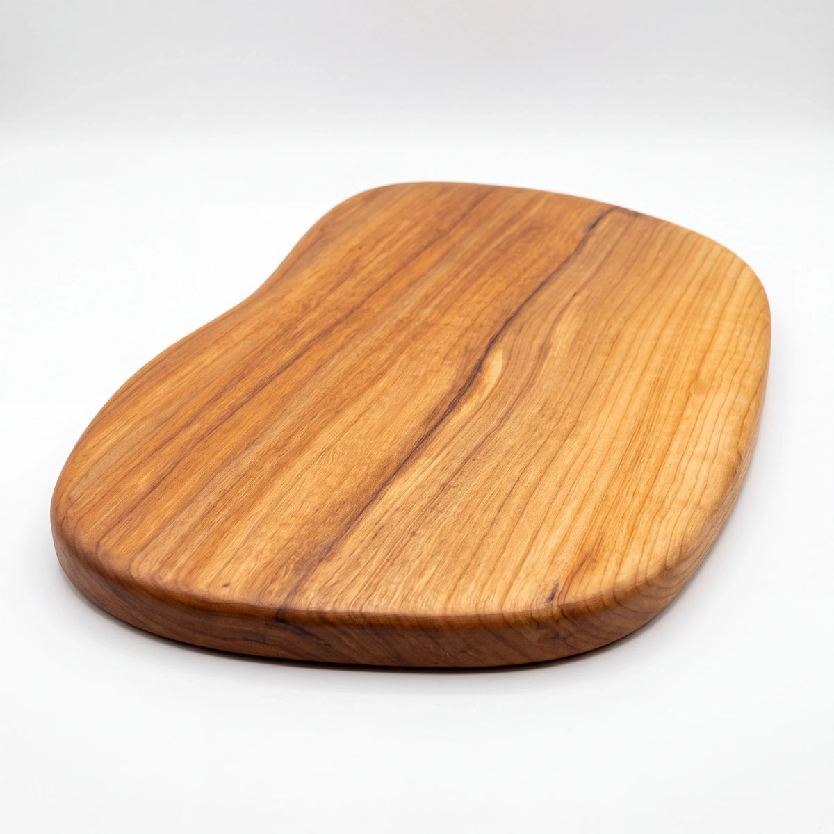 Crown N Thread handmade wooden charcuterie board with a unique organic shape and smooth lacquered finish