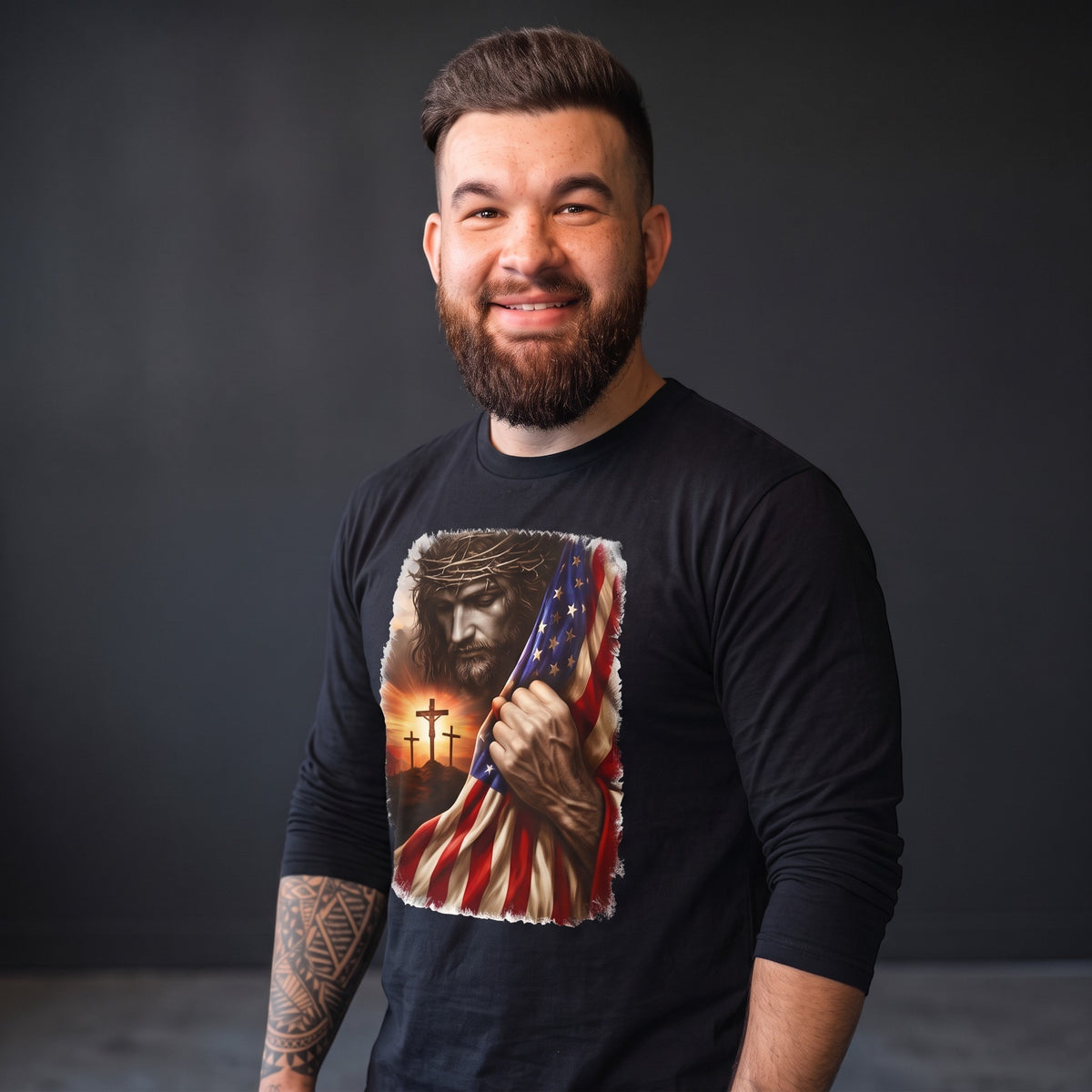 Crown N Thread black long sleeve tee featuring a graphic of Jesus, three crosses, and an American flag at sunset.