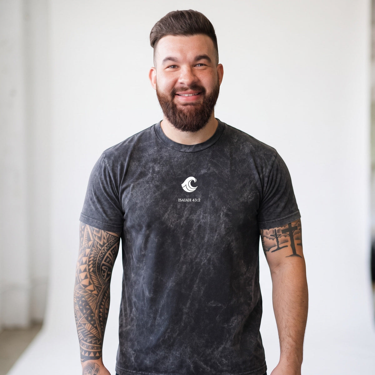 A man wearing a Crown N Thread mineral-washed black cotton crewneck t-shirt with a white whale and Isaiah 43:2 print.