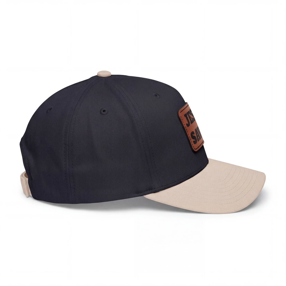 Crown N Thread baseball cap with navy crown, beige visor, and Jesus Saves vegan leather patch on the side