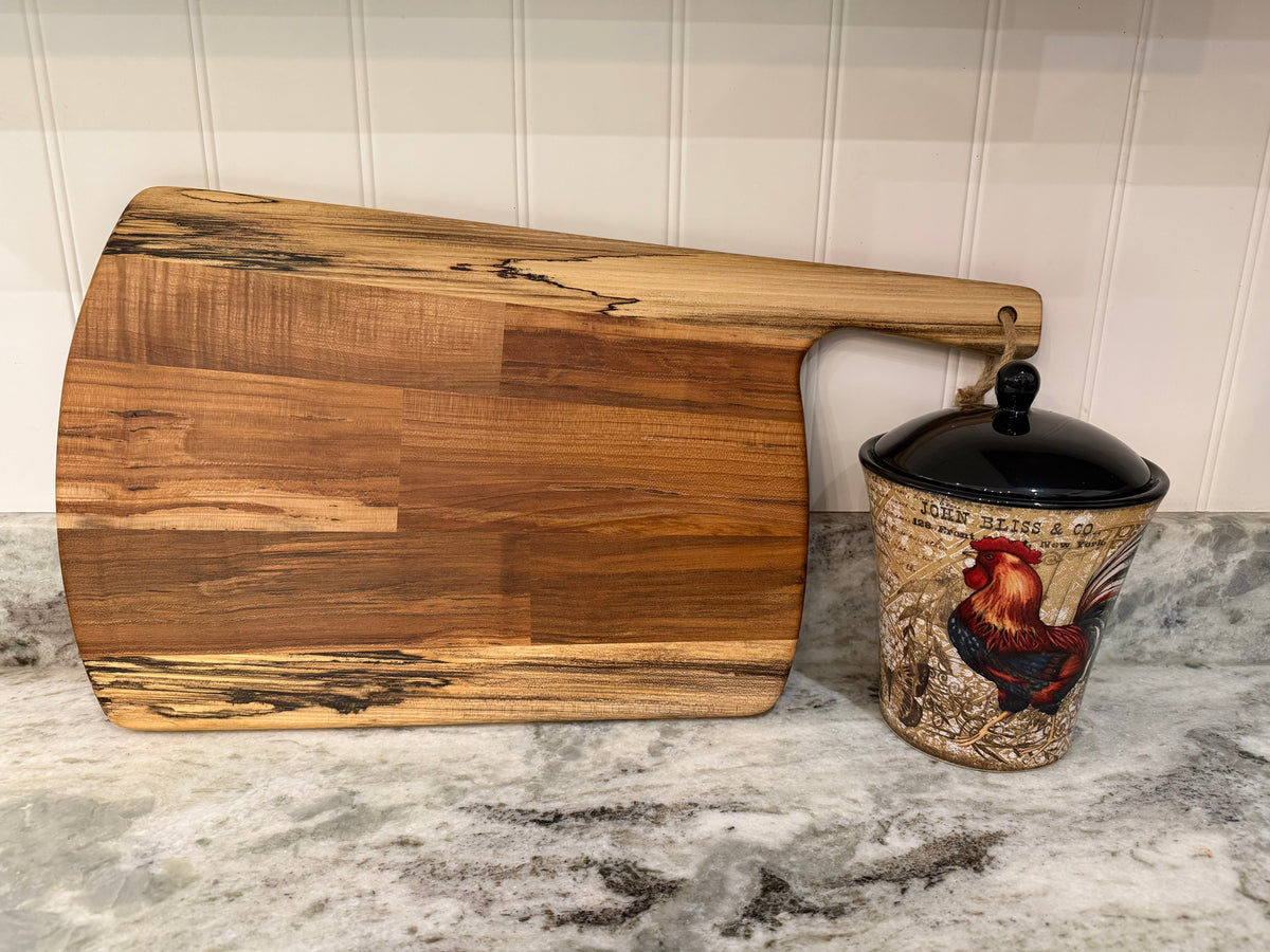 Crown N Thread handmade oiled wood charcuterie board with natural grain patterns and a convenient hanging handle