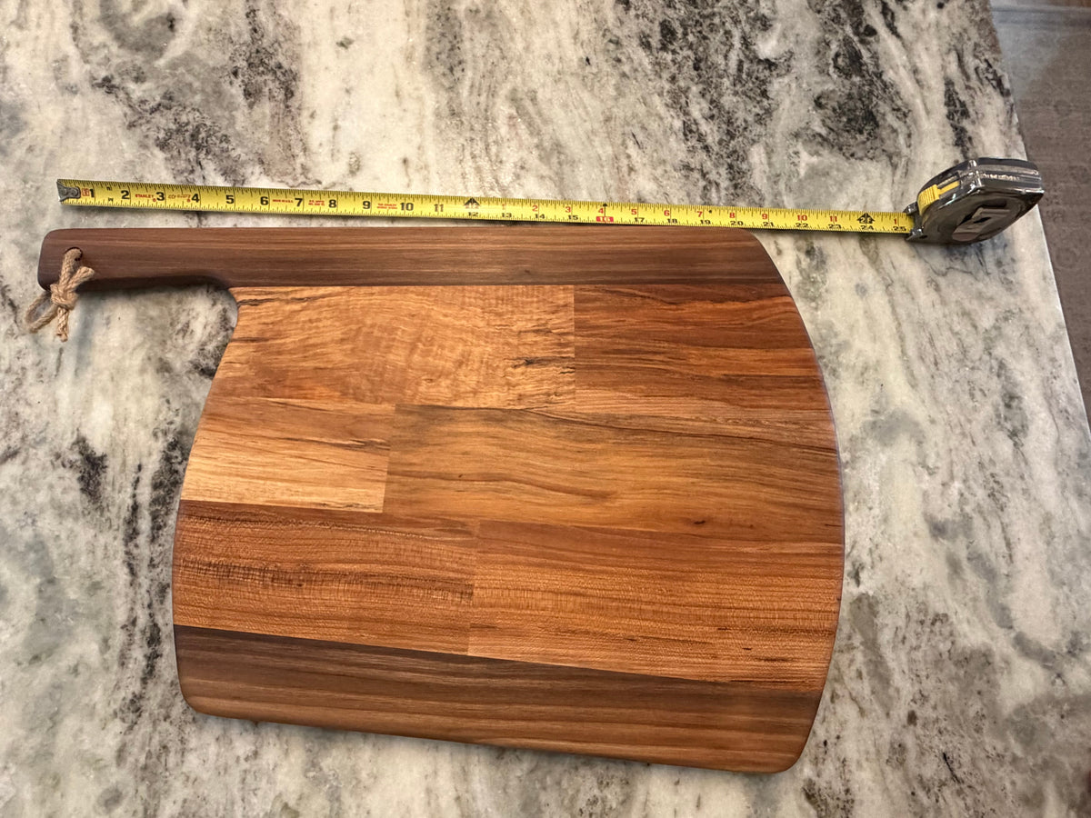 Crown N Thread handmade oiled wood charcuterie board with a rustic rope handle and natural grain patterns on marble