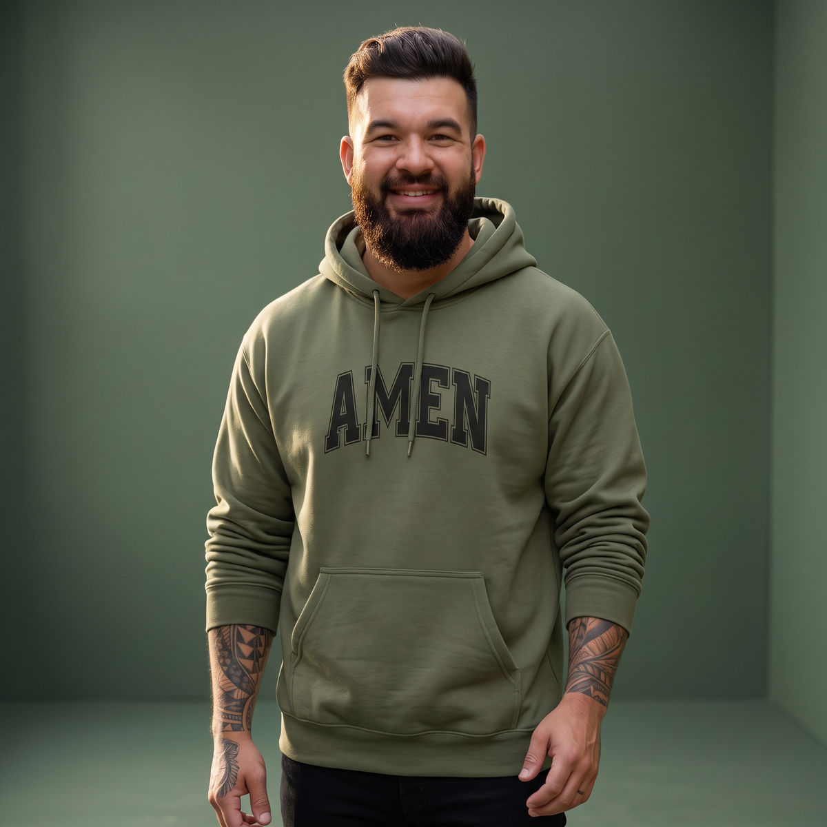 A man wearing a Crown N Thread olive green hoodie with bold black AMEN collegiate lettering and a kangaroo pocket.
