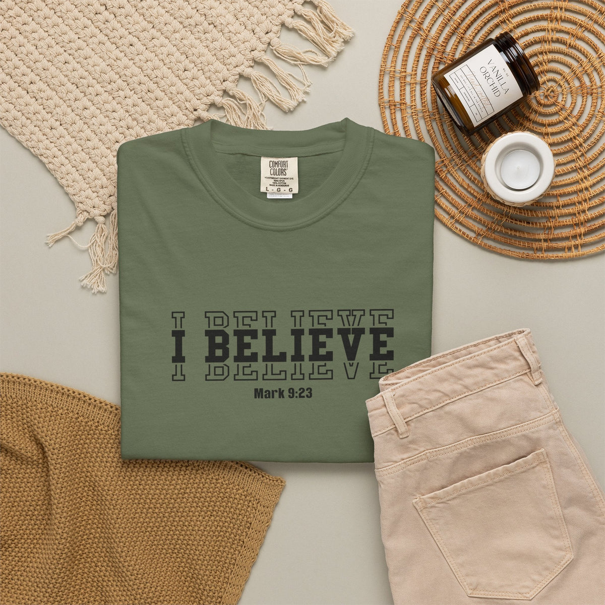 Crown N Thread olive green heavyweight cotton graphic tee with I Believe Mark 9:23 text, flat lay with accessories.