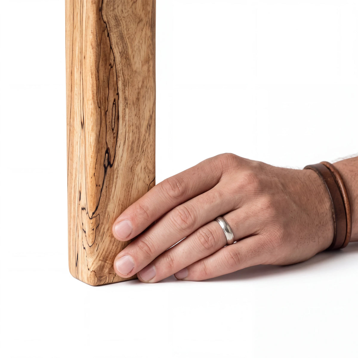 Crown N Thread handcrafted rustic wooden cross with natural grain patterns held by a hand against a white background